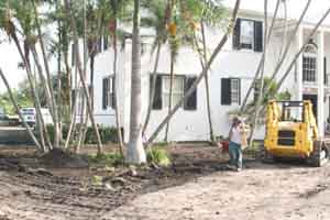 Landscape company crew cleaning up a landscape project in Hollywood Florida