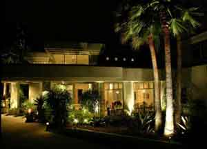 Contemporary house at night with landscape lighting and palm trees in Orlando Florida