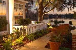 Landscape pathway lights along a sidewalk with ballustrade and landscape plantings